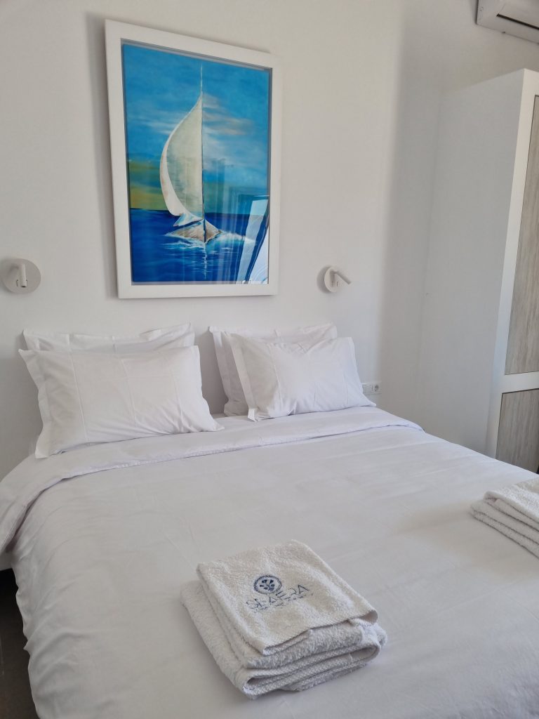 Bright living room with comfortable seating and natural light and decoration seaera luxury apartment Tinos.