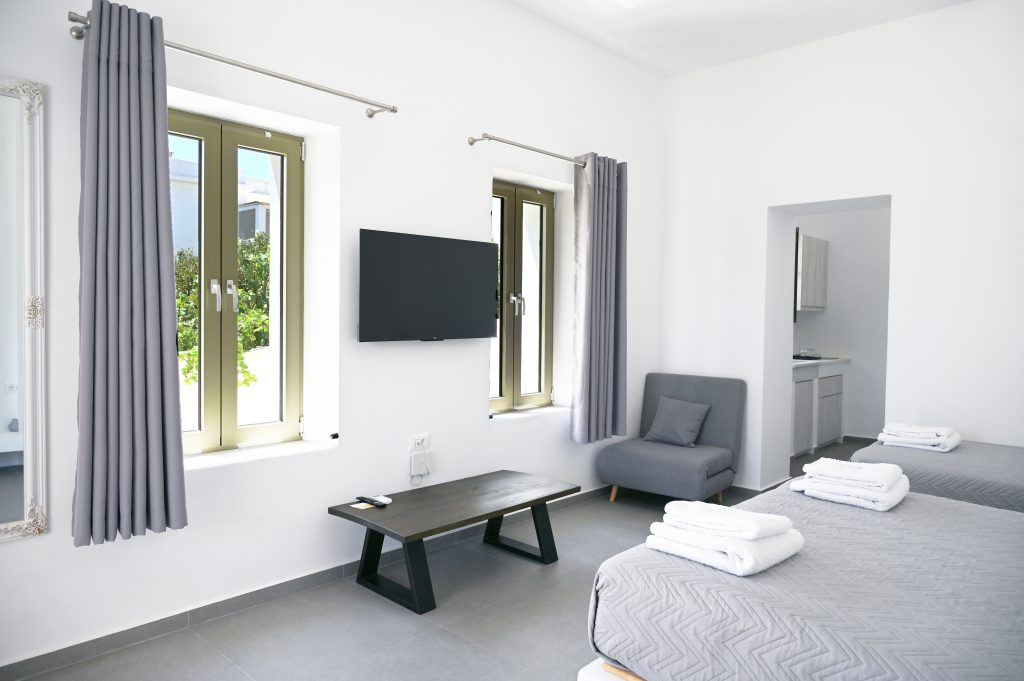 Spacious bedroom featuring a queen-size bed and minimalist decor.