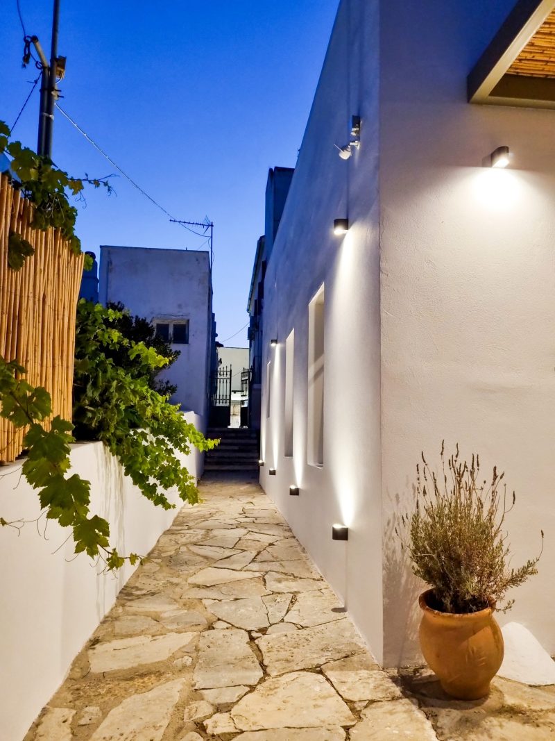White exterior entrnce of Seaera Luxury Tinos Apartment with cycladic architecture.