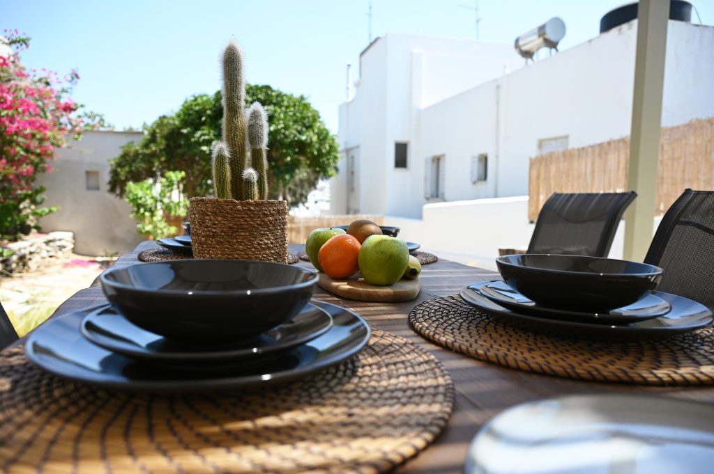 Outdoor patio with seating area overlooking the cycladic garden seaera luxury apartment Tinos